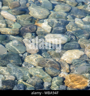 Background of sea colored stones under water Stock Photo