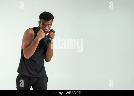 Portrait of sportsman with perfect body standing at the gym after workout  and showing his biceps Stock Photo - Alamy