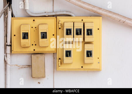 Old Electrical switchboard  on the wall. Stock Photo