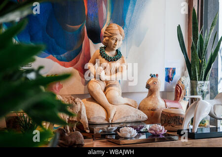 FEB 11, 2014 Chiang Mai, Thailand - Well design Asian style carved wood woman and bird sculpture, ceramic flowers, glass vase, water colour painting f Stock Photo