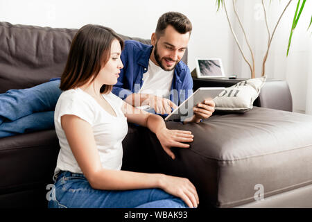 Couple using new app on tablet Stock Photo