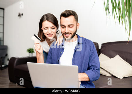 Couple doing online shopping at home Stock Photo
