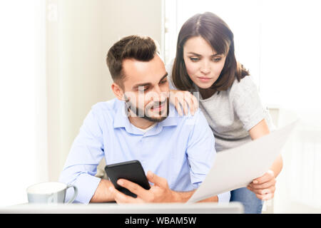 Young couple analyzing papers and documents Stock Photo