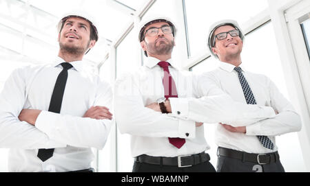 three architects standing in an empty office Stock Photo