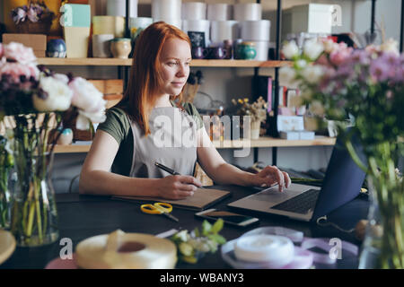Processing online orders in flower shop Stock Photo