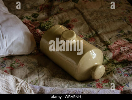 Vintage stoneware hot water bottle, also known as a pig. Stock Photo