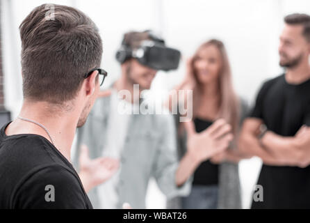 Positive colleagues testing virtual reality glasses Stock Photo