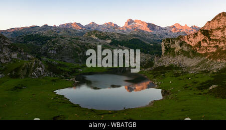 Serene landscape with one of Lakes of Covadonga and mountain range at dusk Stock Photo