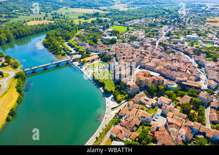 Aerial view of Cazeres cityscape on banks of Garonne river overlooking Catholic church of Our Lady of Cazeres, France Stock Photo