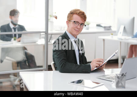 Cheerful Young Entrepreneur at Workplace Stock Photo