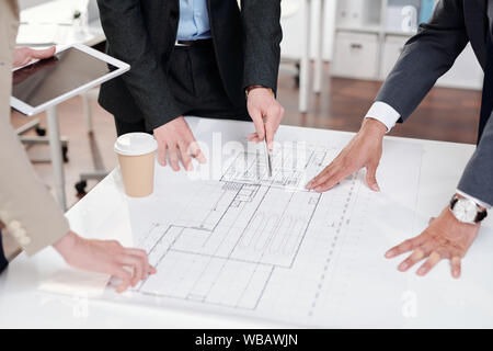 Business People Discussing Floor Plans Stock Photo