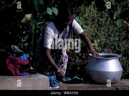 asia, asian india native indian cleaning a large utensil container Stock Photo