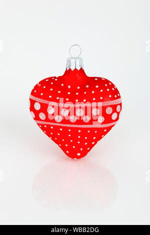 Heart-shape Christmas bauble in red and white. Studio picture against a white background. Switzerland Stock Photo