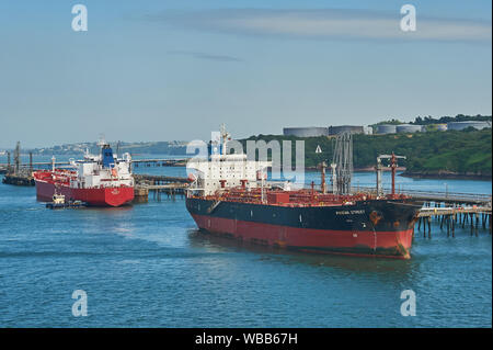Oil and petro-chemical tankers moored to pontoons serving Milford Haven refineries in South Wales.