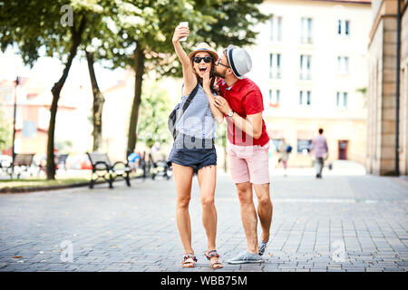 Loving young couple taking selfie and having fun while on vacation together Stock Photo