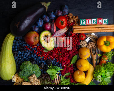 Foods rich in fiber as bread sticks, wheat, white beans, lentils, spinach, nuts, seed, pears, bananas, berries, avocado, plums, eggplant, broccoli Stock Photo