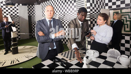 Portrait of confused thinking man in business suit in escape room Stock Photo
