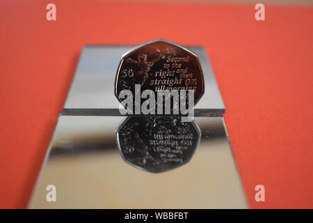 Peter Pan 50p with mirror reflection and colourful background. Stock Photo