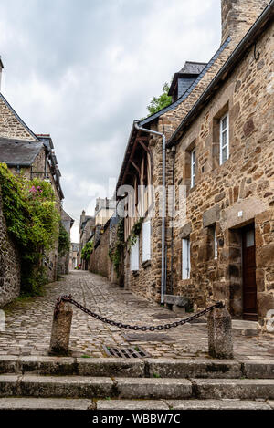 Dinan, France - July 26, 2018: Old cobblestoned street with stone medieval houses in the town centre of Dinan, French Brittany Stock Photo