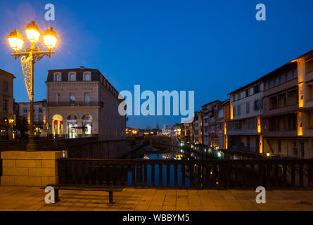 Scenic view of illuminated houses along Agout river in French city of Castres in twilight