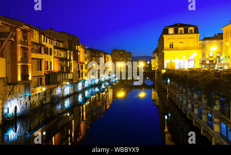 Night view of city of Castres with lighted buildings along river Agout, France