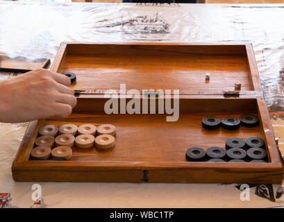 Playing backgammon on a wooden table with dices. Stock Photo
