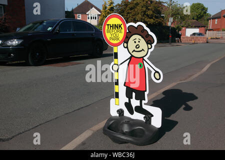 A sign outside an infants’ school to try to persuade parents to think before they park and to park in a safe place Stock Photo