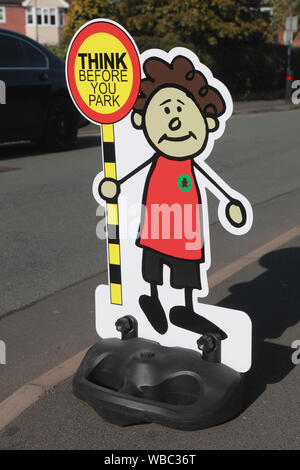 A sign outside an infants’ school to try to persuade parents to think before they park and to park in a safe place Stock Photo