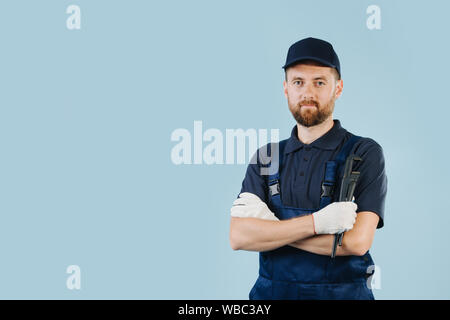 Portrait of a confident service worker with hands crossed, dressed in uniform Stock Photo