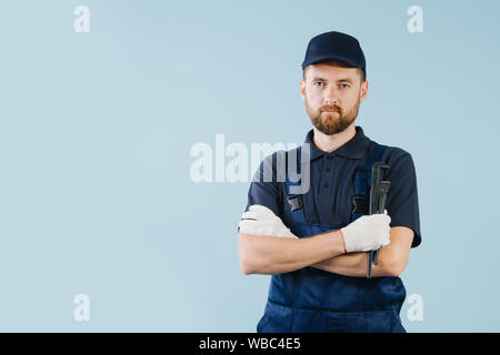 Portrait of a serious service worker with hands crossed, dressed in uniform Stock Photo