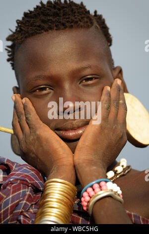 Beautiful young tribal Mursi woman in the Mago National Park, Lower Omo Valley, Ethiopia Stock Photo