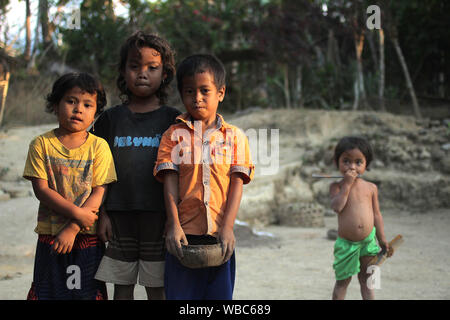 Sengkol, Lombok, Indonesia - September 20, 2017: four preschool aged children posing in rural Indonesian village Stock Photo