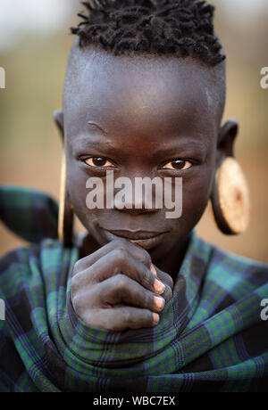 Beautiful young tribal Mursi woman in the Mago National Park, Lower Omo Valley, Ethiopia Stock Photo