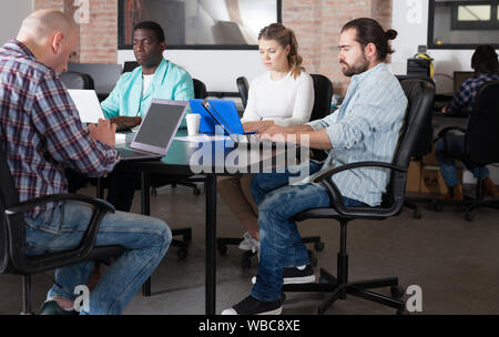 Multiethnic startup business team working on new project in loft style coworking space Stock Photo