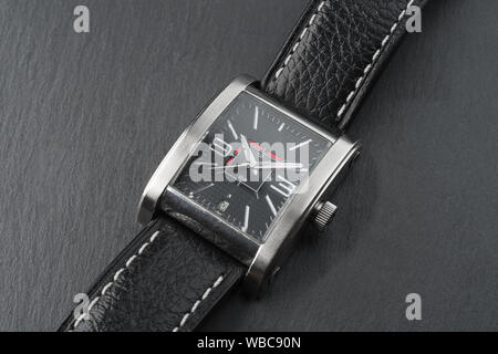 Elegant expensive square shaped wrist watch with black leather strap on ...