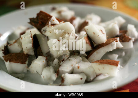 close up of chopped pieces of coconut on a white plate Stock Photo