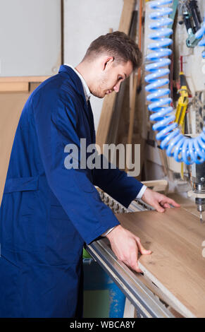 american guy using drilling machine at workshop Stock Photo