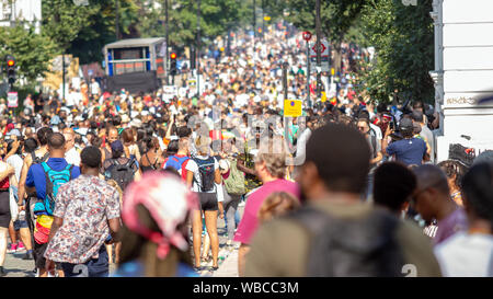 A view of the crowds as Carnival went into full swing. The main events of Notting Hill Carnival 2019 got underway on Sunday, with over a million revellers hitting the streets of West London, amongst floats, masqueraders, steel bands, and sound systems. Stock Photo