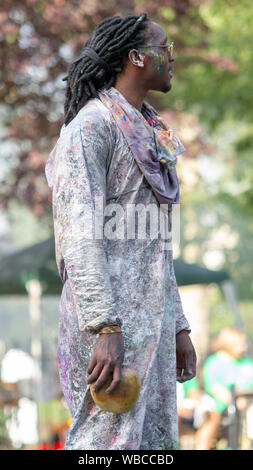 A reveller who played 'dirty mas' in the morning, a tradition where powders and paint are thrown over each other taking part. The main events of Notting Hill Carnival 2019 got underway on Sunday, with over a million revellers hitting the streets of West London, amongst floats, masqueraders, steel bands, and sound systems. Stock Photo