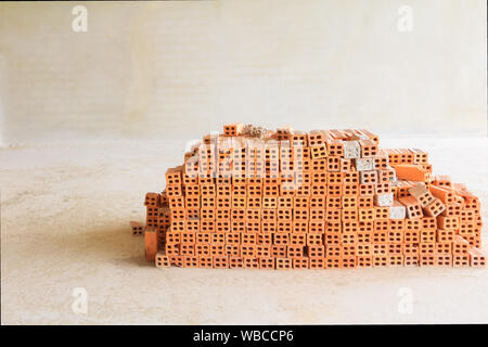 Red bricks pile interior room building construction and cement wall background Stock Photo