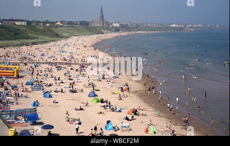 People on Long Sands Beach, Tynemouth, as they enjoy the sunshine on the late August bank holiday. Stock Photo