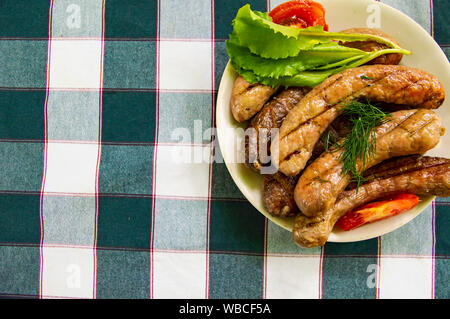 Bavarian sausages with vegetables on a plate. Place for text. Stock Photo