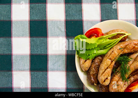 Bavarian sausages with vegetables on a plate. Place for text. Stock Photo