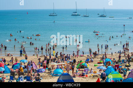 Lyme Regis, Dorset, UK. 26th Aug, 2019. UK Weather: Crowds of beachgoers flock to the seaside of resort of Lyme Regis to bask in the sun another day of scorching hot sunshine and record breaking tenperatures. The beach is packed again as the soaring temperatures are set to make this the hottest August bank holiday since records began.  Credit: Celia McMahon/Alamy Live News Stock Photo