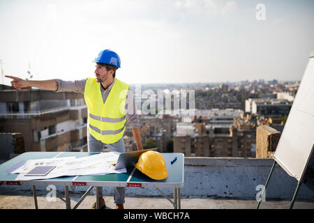 Young man architect, construction engineer at a construction site Stock Photo