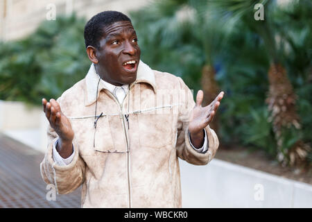 Portrait of bewildered African-American man in overcoat Stock Photo