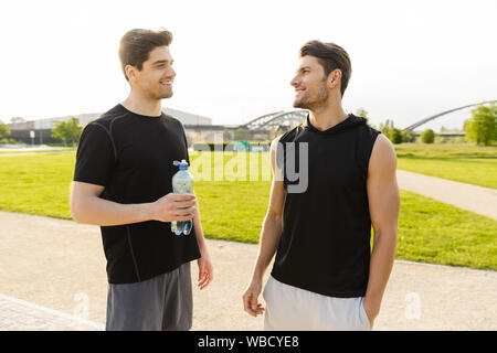 Guys working out together in gym motivating each other Stock Photo - Alamy