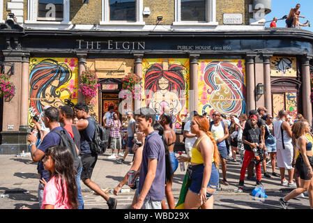 London, UK.  26 August 2019.  Visitors enjoy the atmosphere around the Grand Finale Parade at the Notting Hill Carnival.  Over one million revellers are expected to visit Europe's biggest street party over the Bank Holiday Weekend in a popular annual event celebrating Caribbean culture.  Credit: Stephen Chung / Alamy Live News Stock Photo