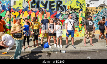 London, UK.  26 August 2019.  Visitors enjoy the atmosphere around the Grand Finale Parade at the Notting Hill Carnival.  Over one million revellers are expected to visit Europe's biggest street party over the Bank Holiday Weekend in a popular annual event celebrating Caribbean culture.  Credit: Stephen Chung / Alamy Live News Stock Photo