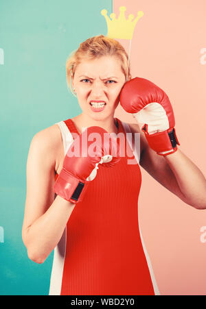 VIP gym. Fighting queen. Woman boxing glove and crown symbol of princess. Queen of sport. Become best in boxing sport. Feminine tender blonde with queen crown wear boxing gloves. Fight for success. Stock Photo